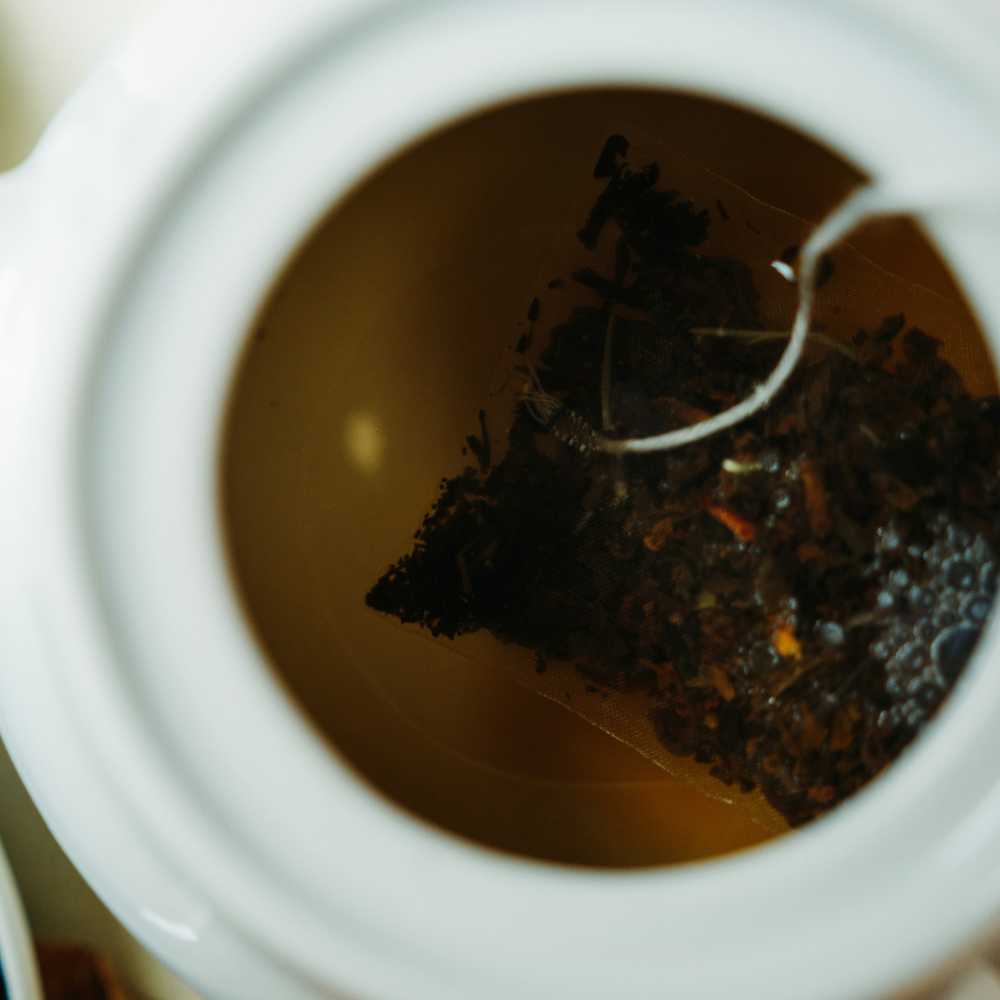 Earl Grey tea steeping in hot water as the base for a homemade London Fog tea latte.