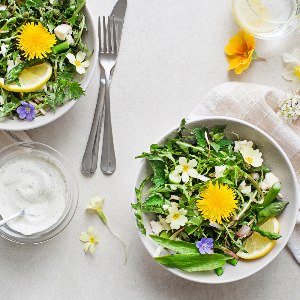 Assorted easy summer salads served on a picnic table with fresh fruit, greens, and Mediterranean ingredients