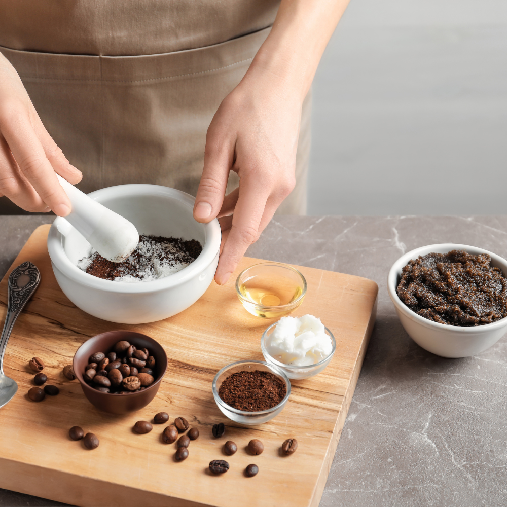 Mixing coffee grounds, sugar, and natural oils to make a DIY coffee scrub