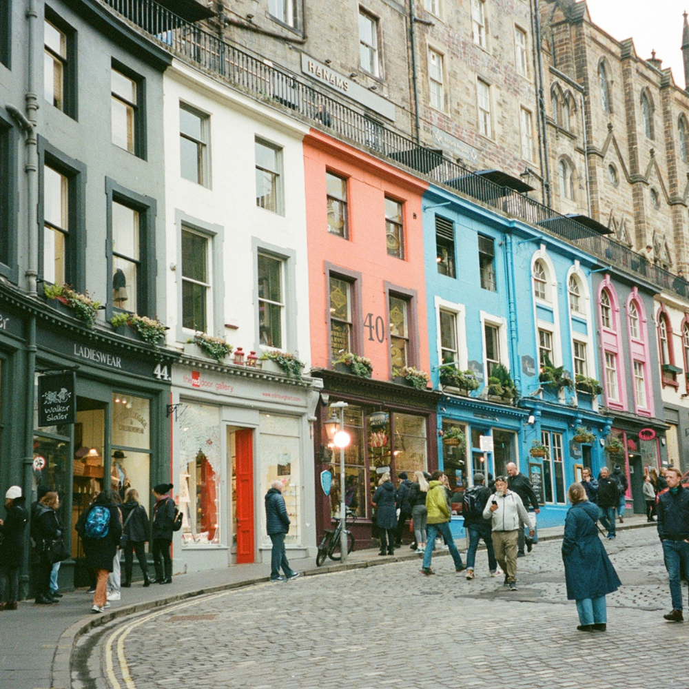 Colorful, curved façades of Victoria Street in Edinburgh’s Old Town leading down to the Grassmarket.