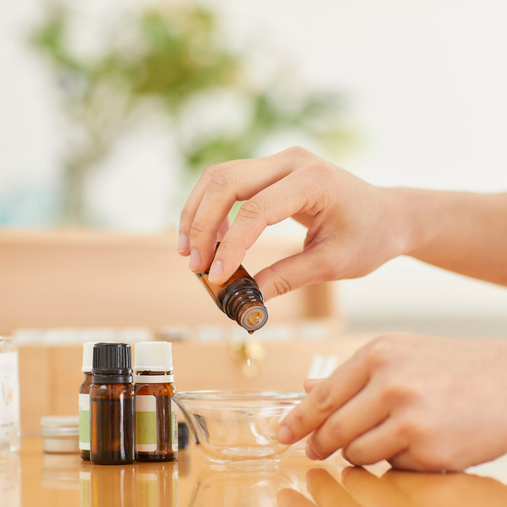Natural oils used for DIY eyelash serum including castor oil, jojoba oil, almond oil, and vitamin E oil arranged for homemade lash serum recipes.