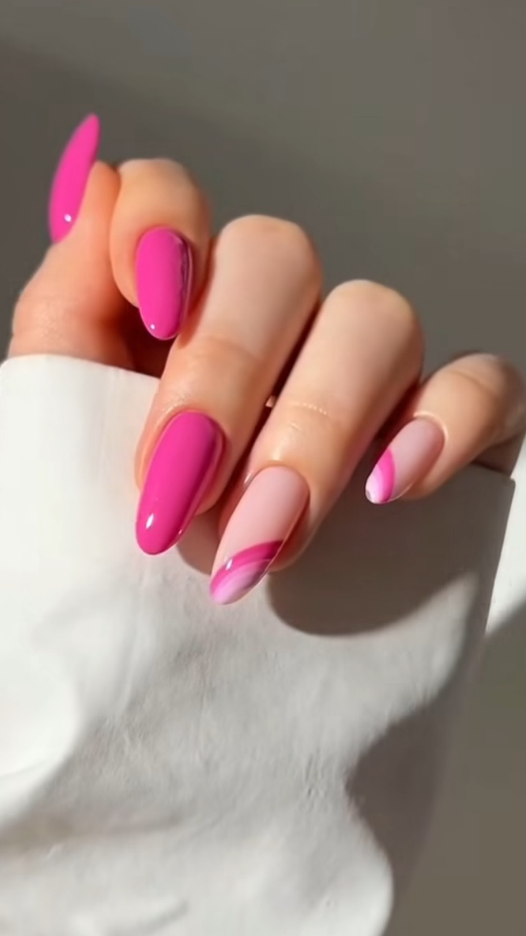 Bold fuchsia spring nails with high-gloss finish on almond shape