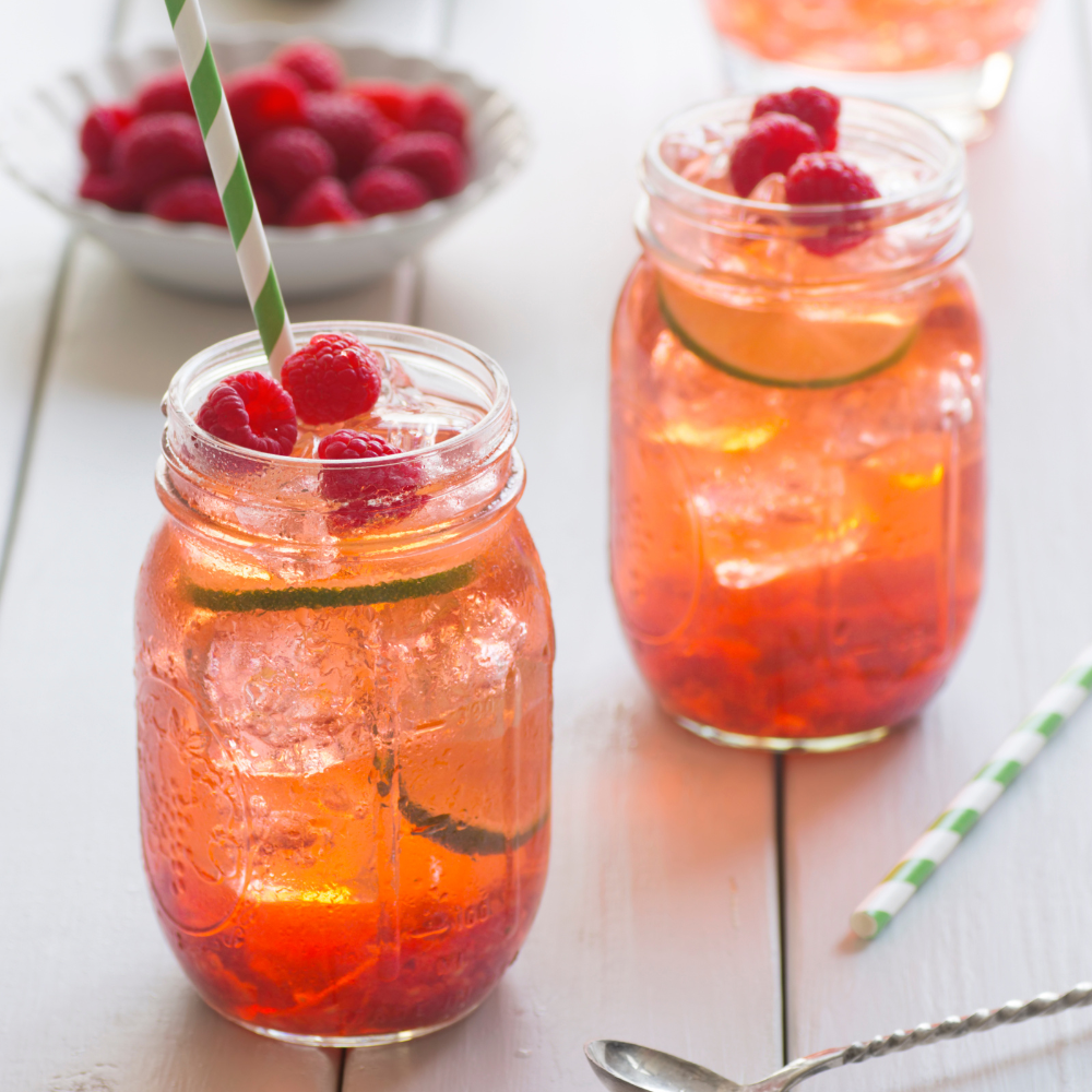 Green iced tea with fresh berries and mint leaves over ice