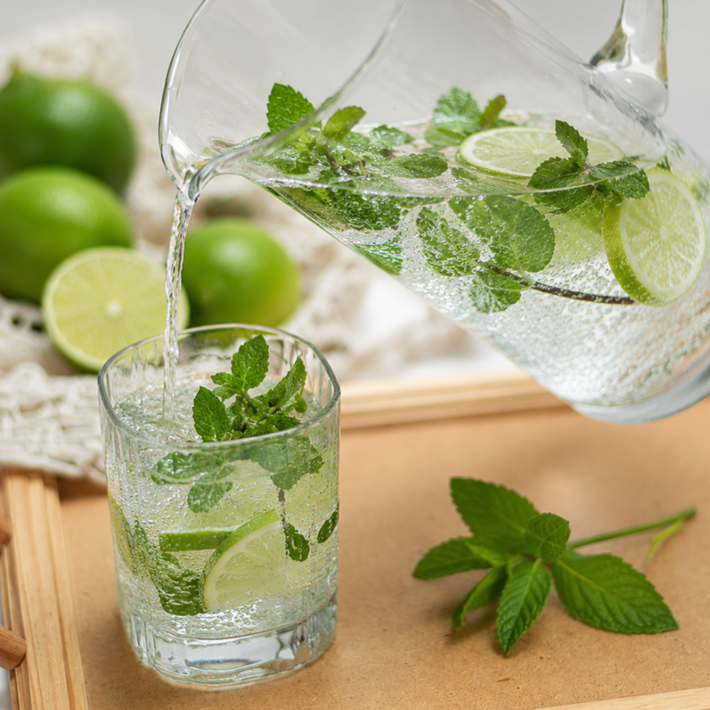 Refreshing non-alcoholic virgin mojito cooler with lime, mint, sparkling water, and ice in a tall glass