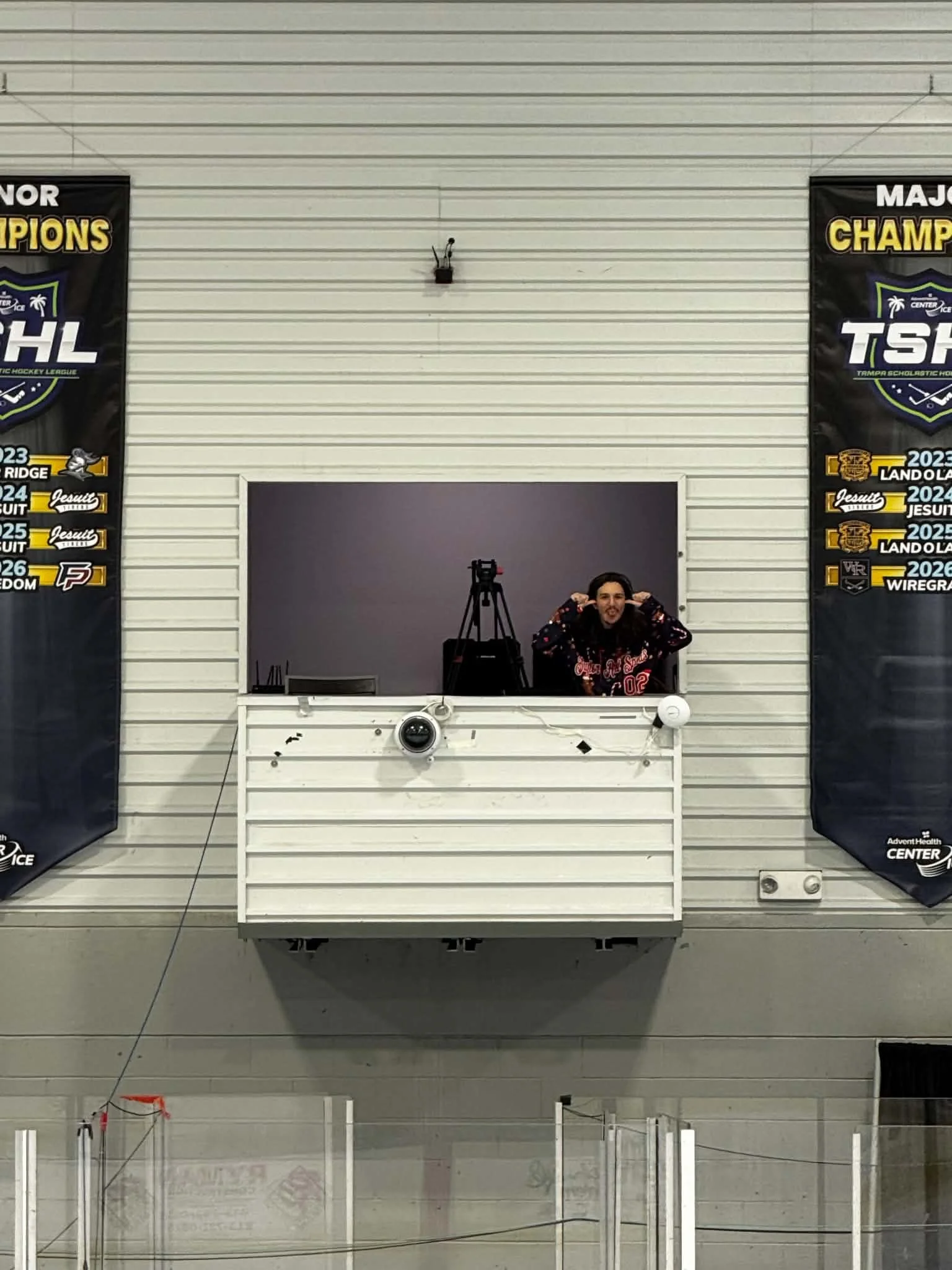 Behind the scenes at the 2026 Sunshine State Synchro Classic. Keegan takes a moment in the elevated camera booth at AdventHealth Center Ice, where our OBSBOT Tail 2 helped capture synchronized skating performances from a unique perspective.