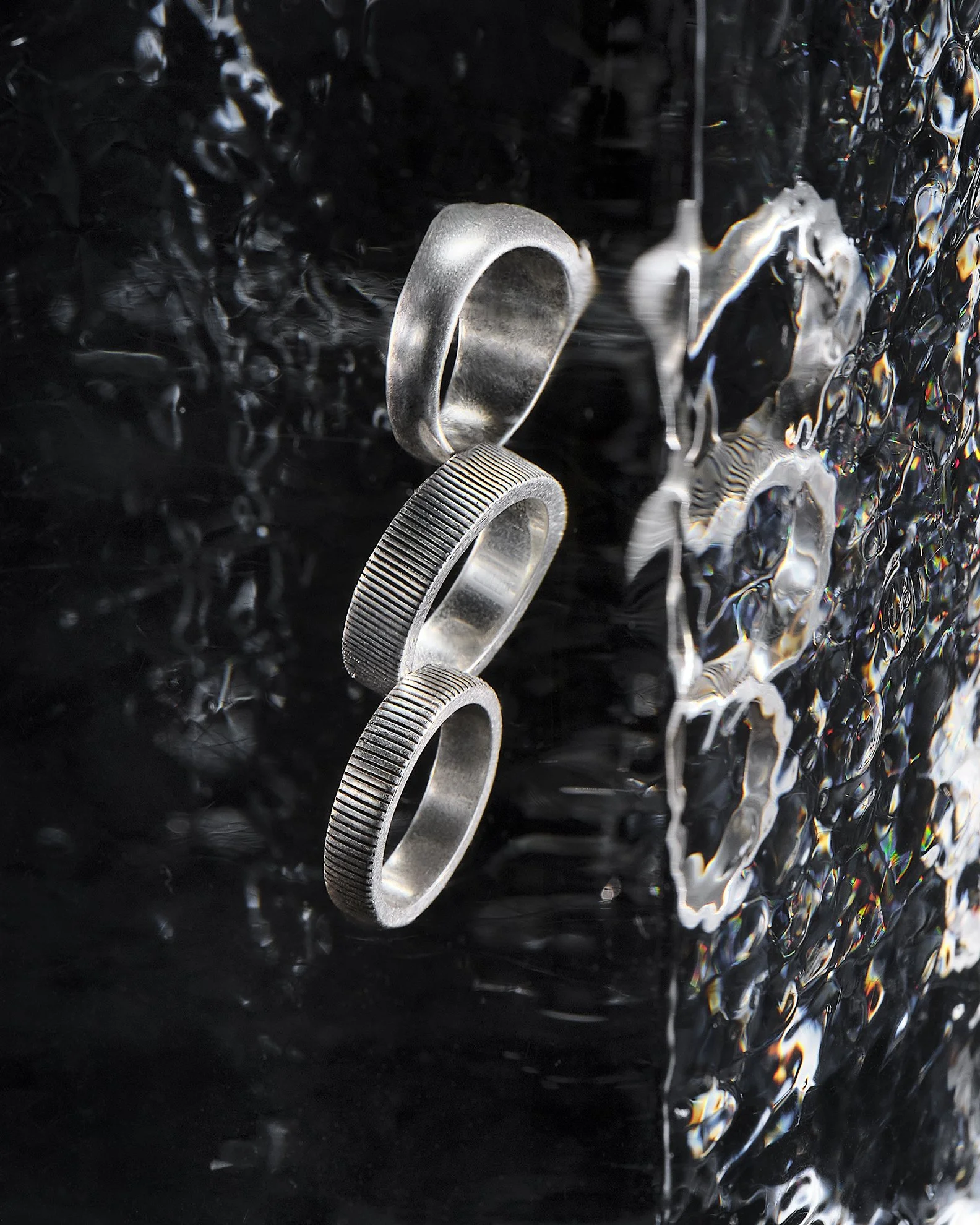Luxury AllSaints accessories encased in ice for a conceptual Christmas still-life campaign photographed by Cara Johnson.