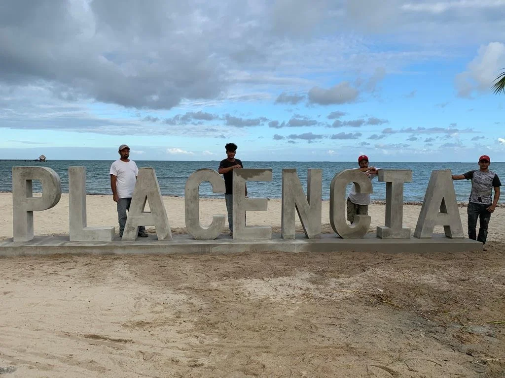 Vision Properties Construction Crew builds "Placencia" sign in the village