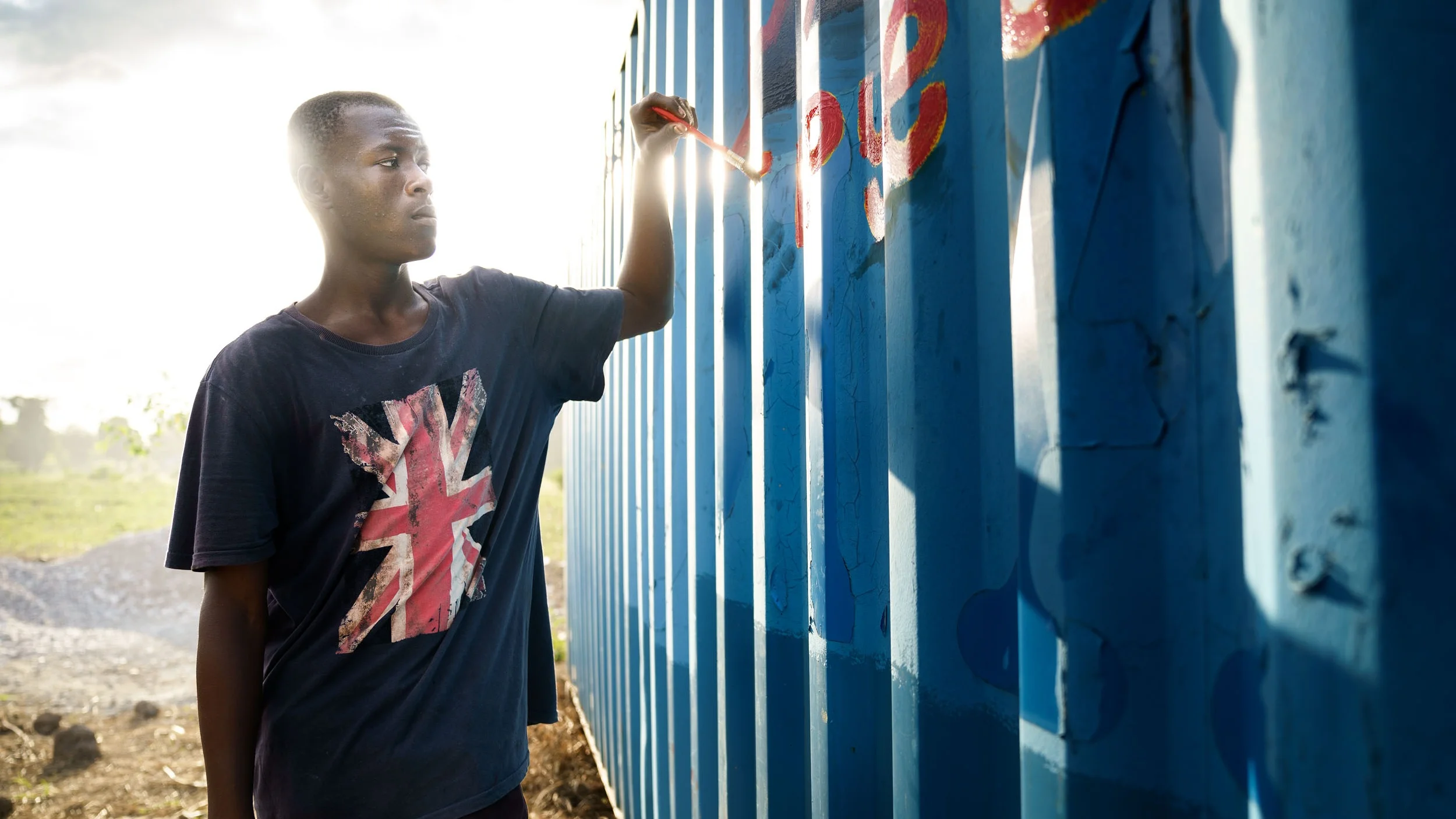 Former street child, Job, now lives with his mother and father in a house provided by LFBS. We have supported his education since 2012. He has incredible artistic and academic talent. Photo by GBP Creative. © 2019 Shot In The Dark Media.