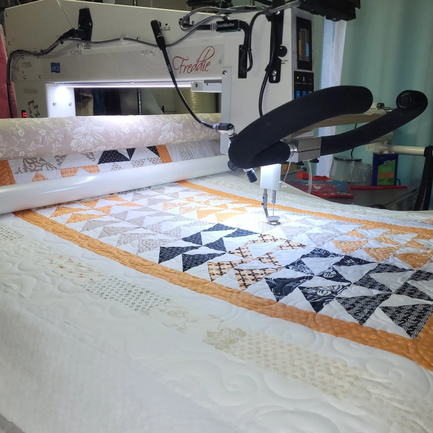 I know I've said it probably a hundred times at this point, but boy do I love how a quilt, or in this case table runner, looks on the longarm frame!

This is Kimberly's flying geese table runner and if you're dying to see more of it, check out yester