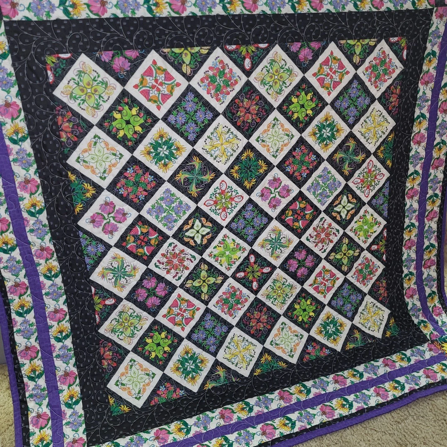 This stunning quilt was fast and fun to make! The center is a giant panel and I love that it looks like an appliqu&eacute; masterpiece! I also love the checkerboard of the cream and charcoal squares, and each fruit and floral sketch within is stunnin