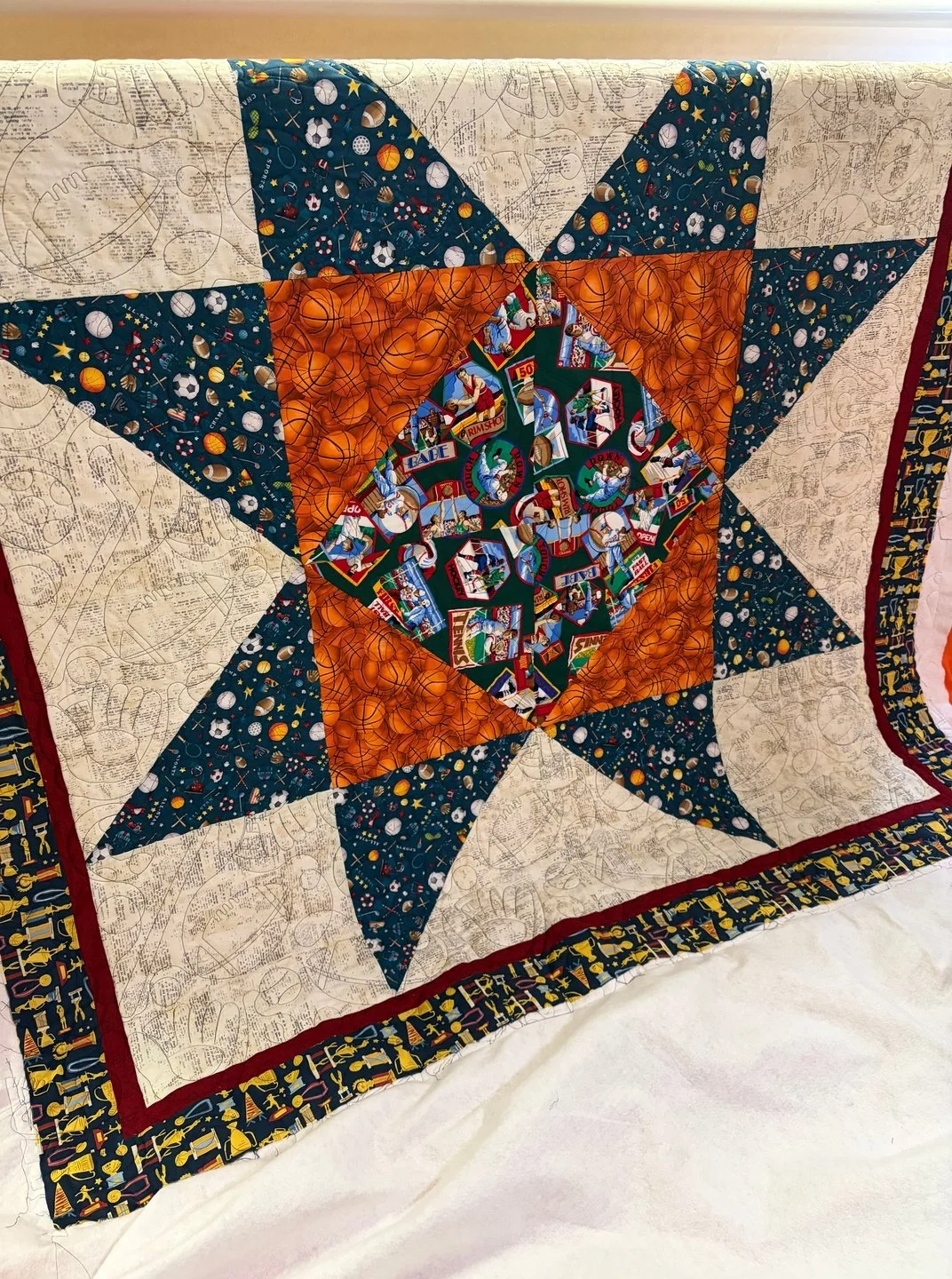 Tina is a master at using bold colors and prints to make amazing quilts! I love it! I also love this bold star quilt design as a great way to showcase different fabrics!

This quilt is a mix of all kinds of sports, so I found the perfect sporty panto