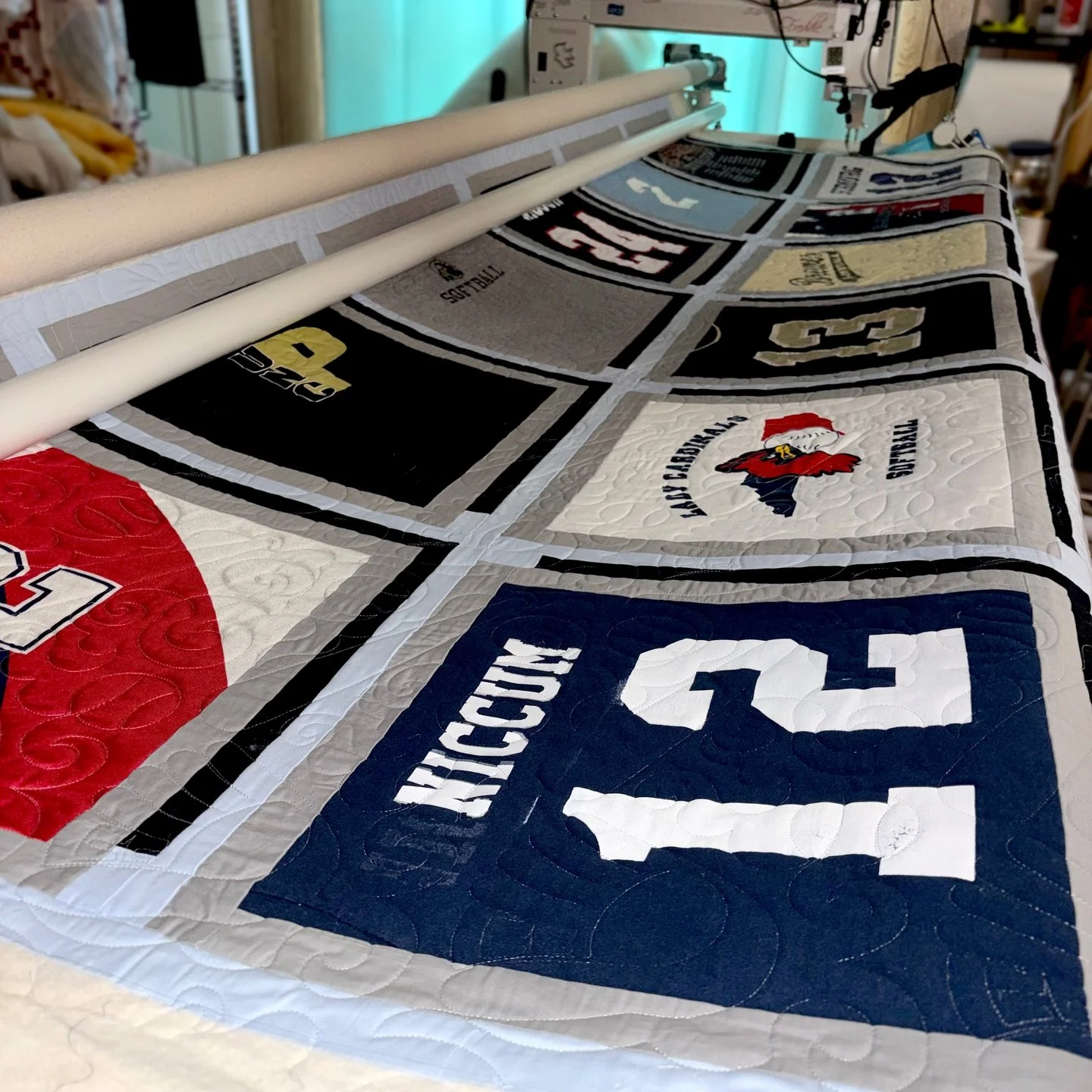 Christine's t-shirt quilt was a whopping 109.25"x127.5"!

It may be the biggest quilt I've ever quilted! I love how Christine framed each t-shirt with a double border, and then finished it off with that blue sashing. It's amazing!

Maker: C