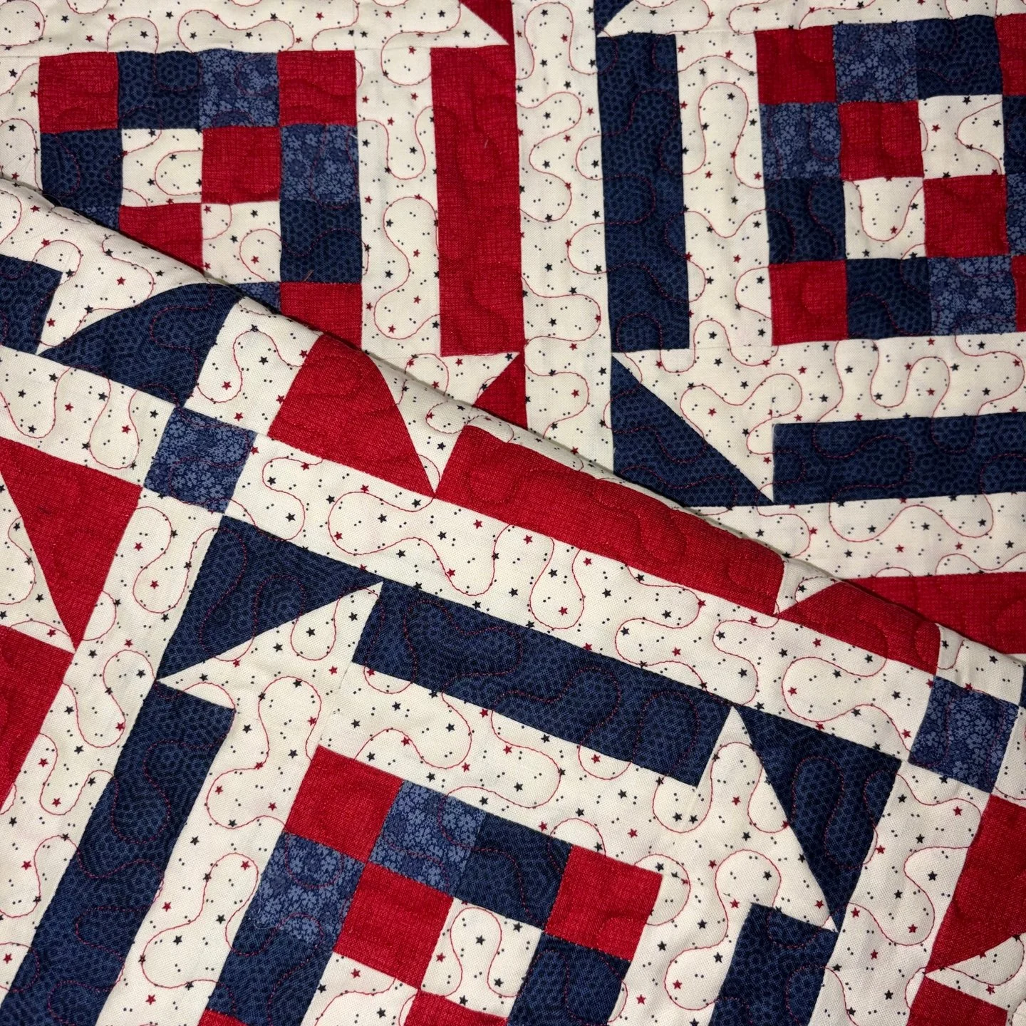 This quilt is full of tiny pieces, but Ellen handled it like a pro! I love the traditional red and blue shades in the fabrics and that printed "backgrround" fabric ties it all together so well!

Ellen chose red thread for the quilting and I