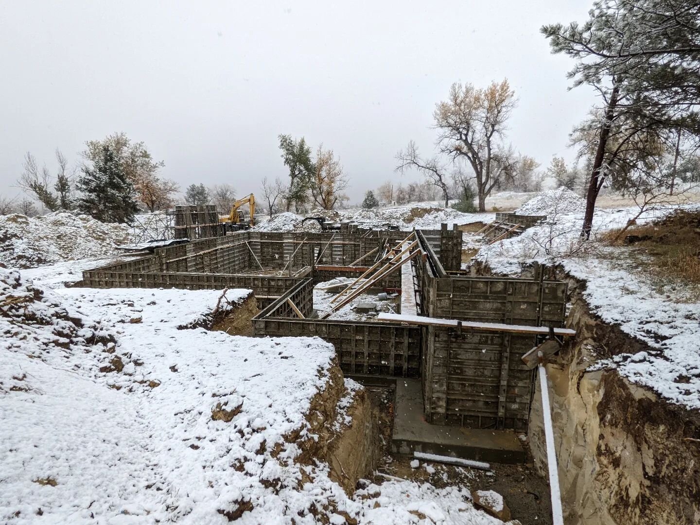 Plowing through the first snow of the year to keep this project moving! Classic Colorado fall weather to inspect footings while sweating and foundation walls while clearing snow off forms ❄️❄️❄️