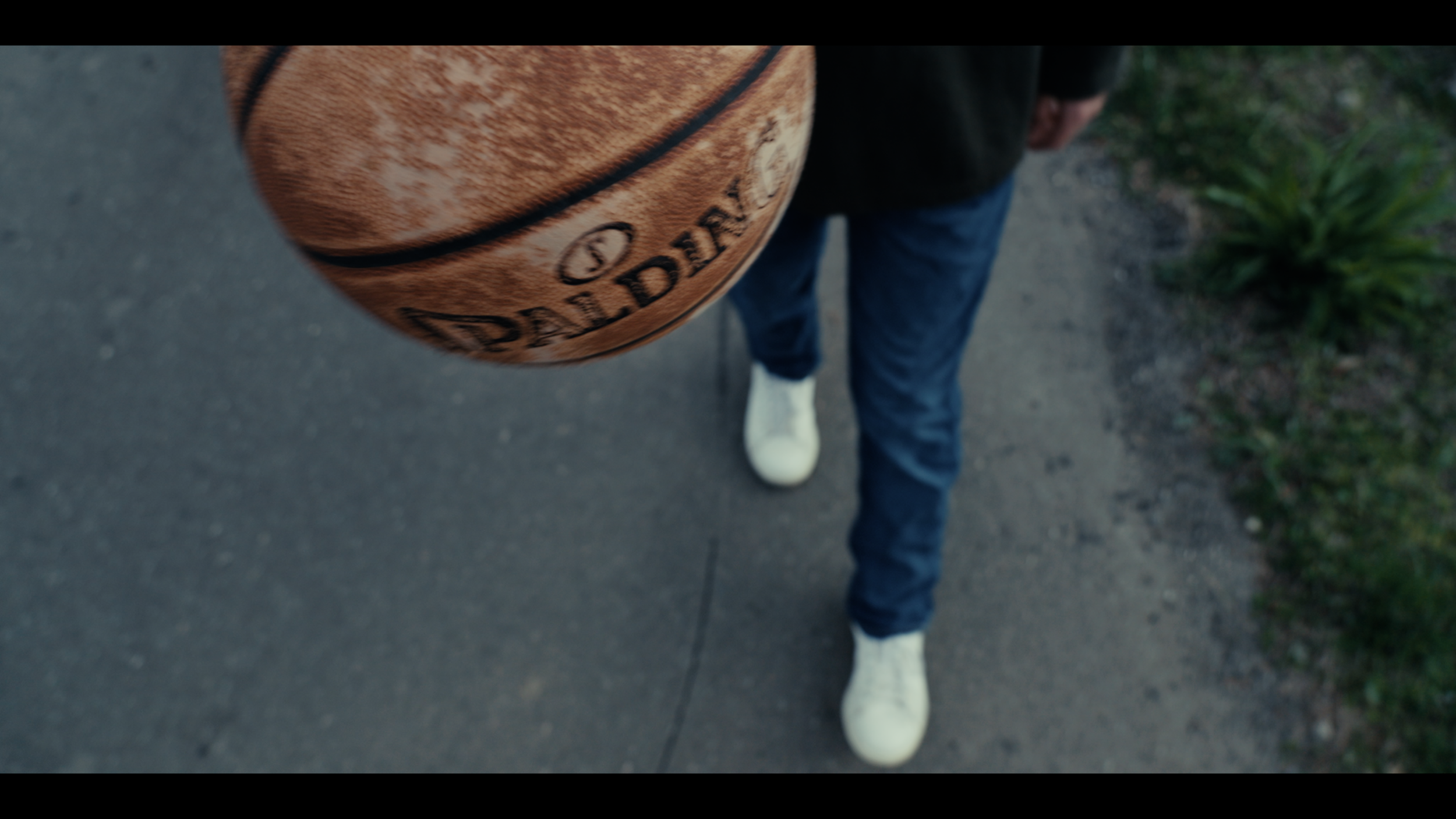 Top Shot of a young boy bouncing a basketball