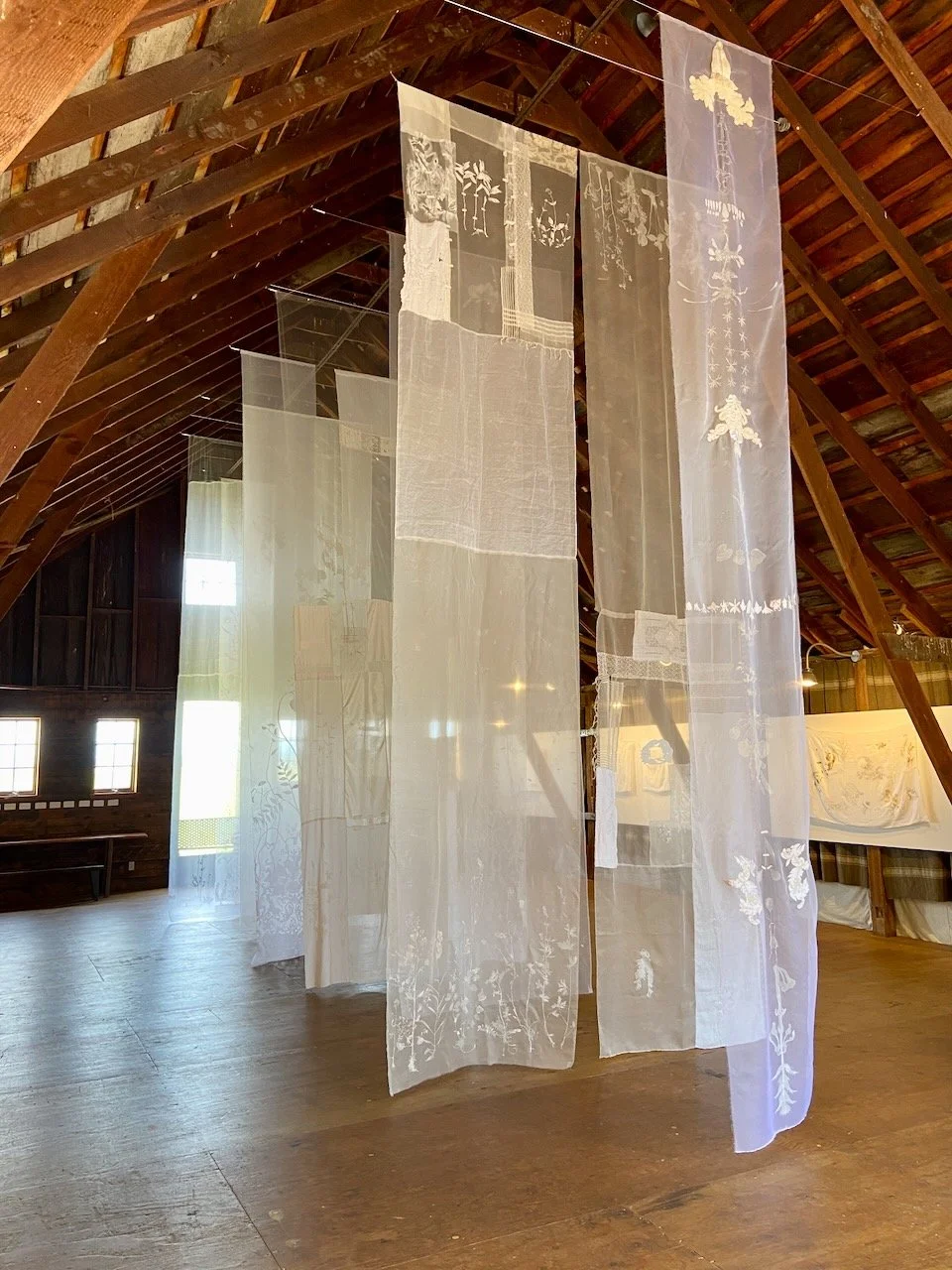 Eidolon (Installation View)  2025  204" x 48" (aprox. size of ea. Banner)   Mixed media on Fabric