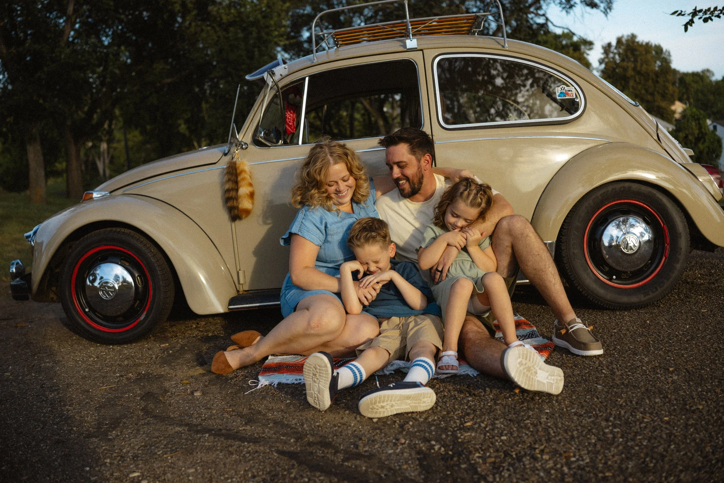 happy family laughing in front of car
