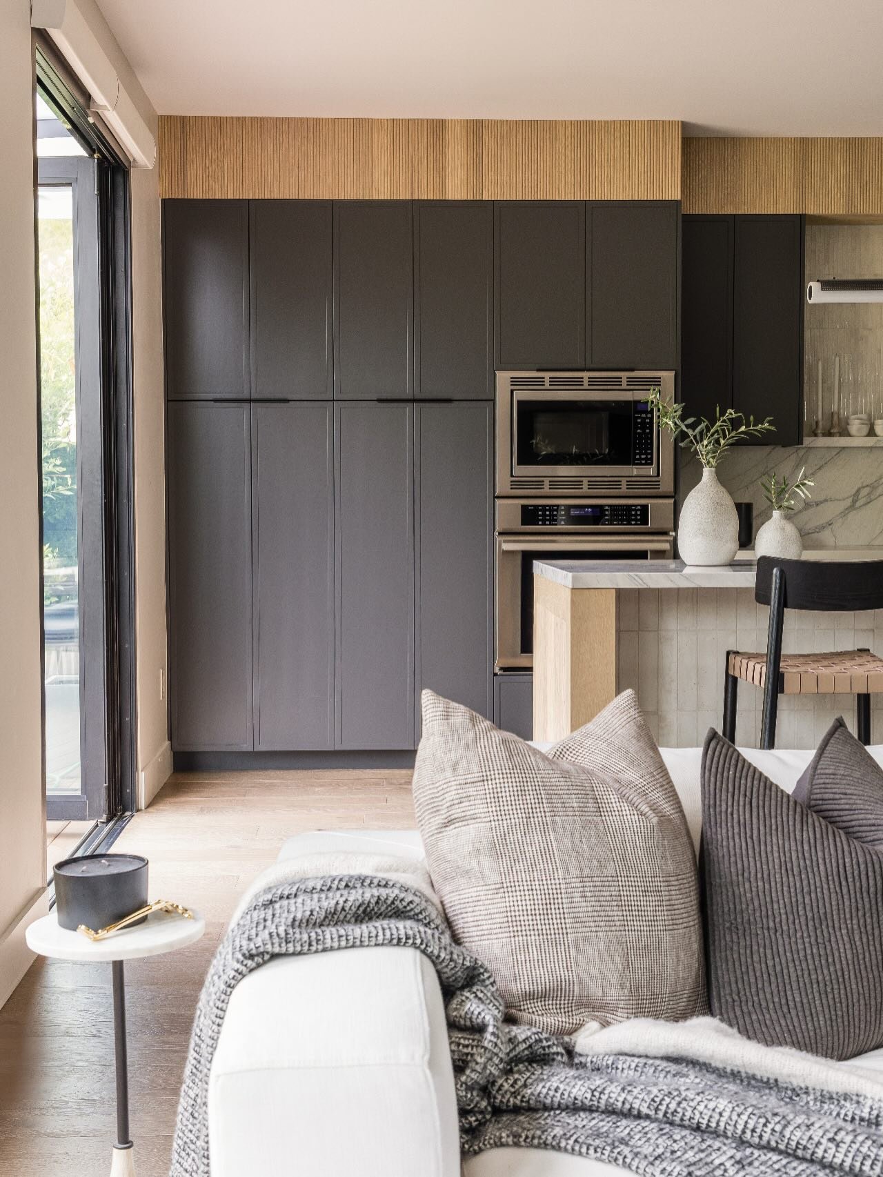Warm woods, moody cabinetry, and a stone moment that anchors the entire space. The PB Beach House kitchen balances texture, contrast, and ease in a way that feels both coastal and elevated. A space designed for gathering, slowing down, and living bea