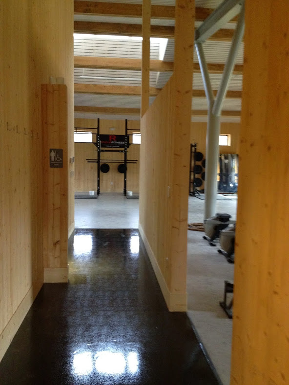  Now, entering the other wing of the building, we see the hallway into the gym. Bathrooms on the left, fitness space on the right. 