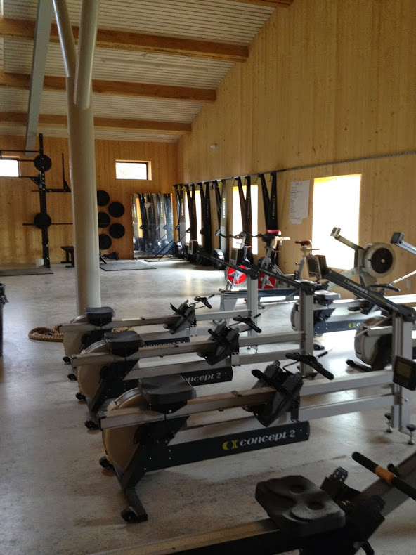  Okay, back to the exciting stuff in the gym. Cardio area with rowing ergs, spin bikes, and SkiErgs. 