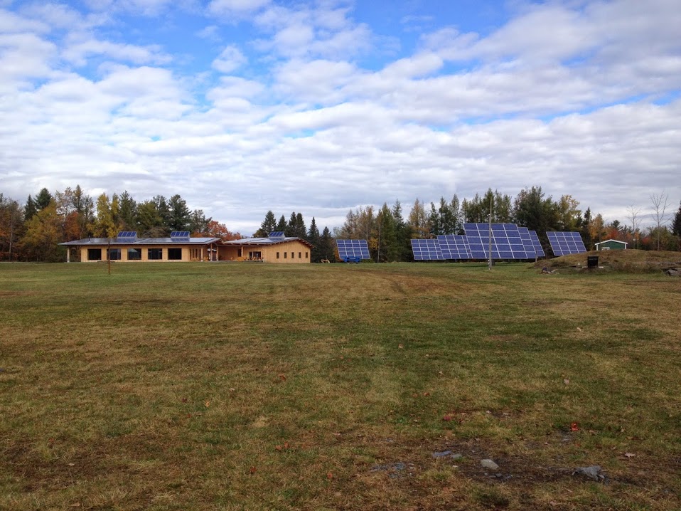  A far-off view, with the Center’s pre-existing solar panels in the field to the right. 