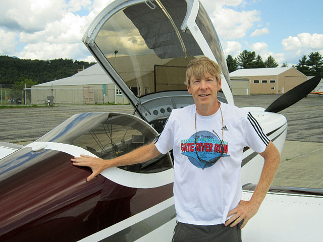 Camper Jeff Smith, next to his plane.