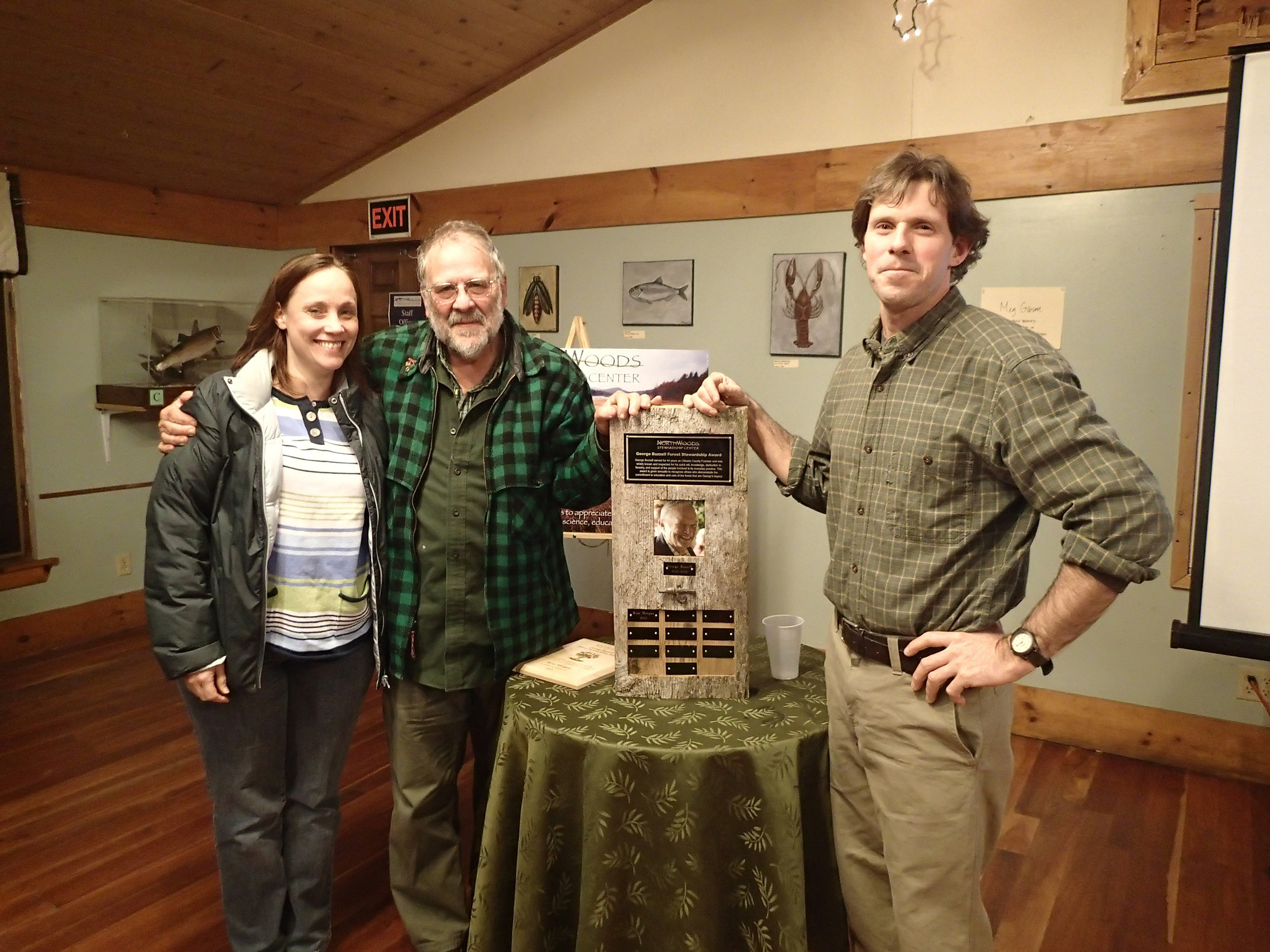 NorthWoods’ Jayson Benoit, right, presents Ross Morgan, center, with the 2013 George Buzzell Forest Stewardship Award, with the help of Buzzell’s daughter, Rebecca Brown, left. - photo from Northwoods.