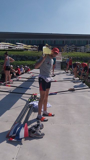 The rowers are catching up with some familiar faces at Worlds. Here, winter GRPer Grant James carries the 4- on dock.