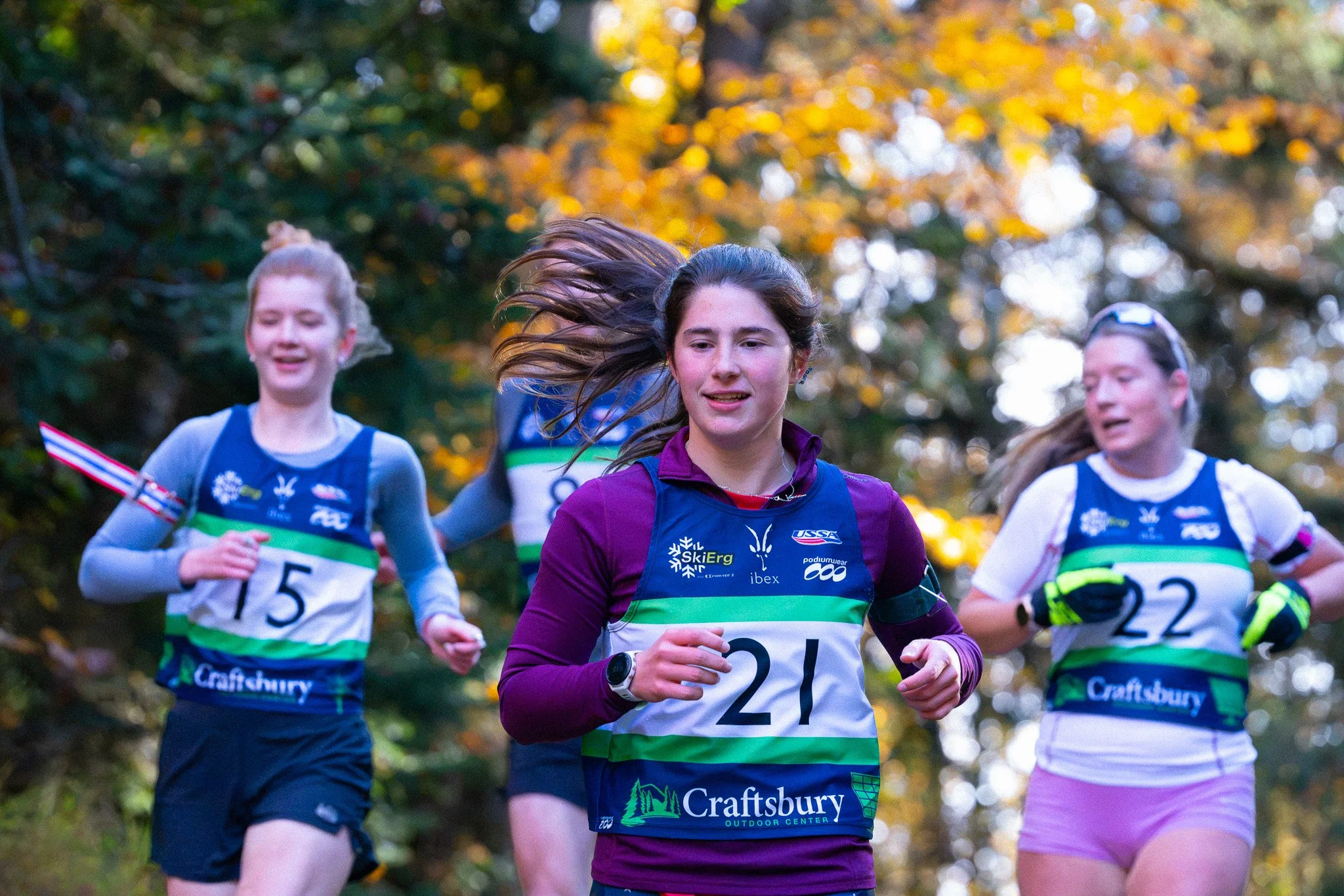 Ava Stratman (21) leads Katja Astrauskas (15) and Ava Uphoff (22) through the foliage in the expert women's run.