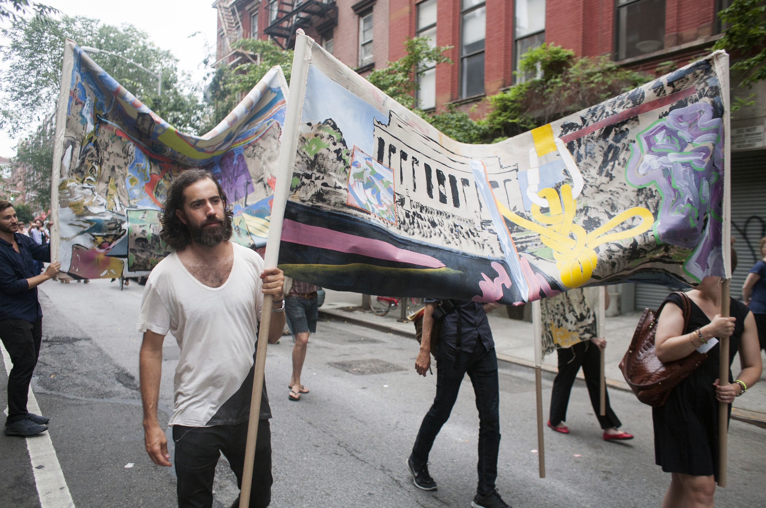  Paul Jacobson and participants carrying banner paintings by Keil Borrman 