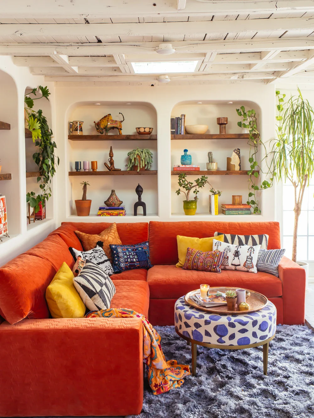 Sofa with a pop of color in a tropical living room