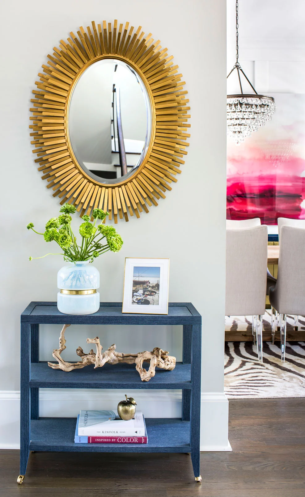 Entryway with gold mirror and navy accent table