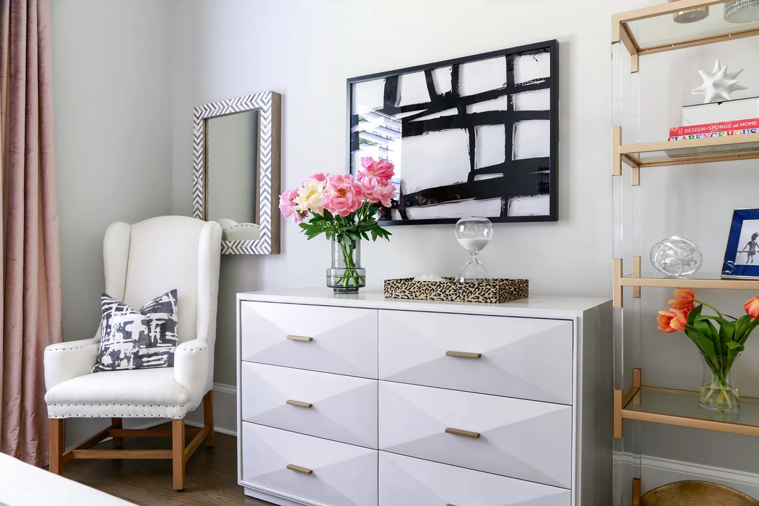 Contemporary guest bedroom with white dresser and glass shelves