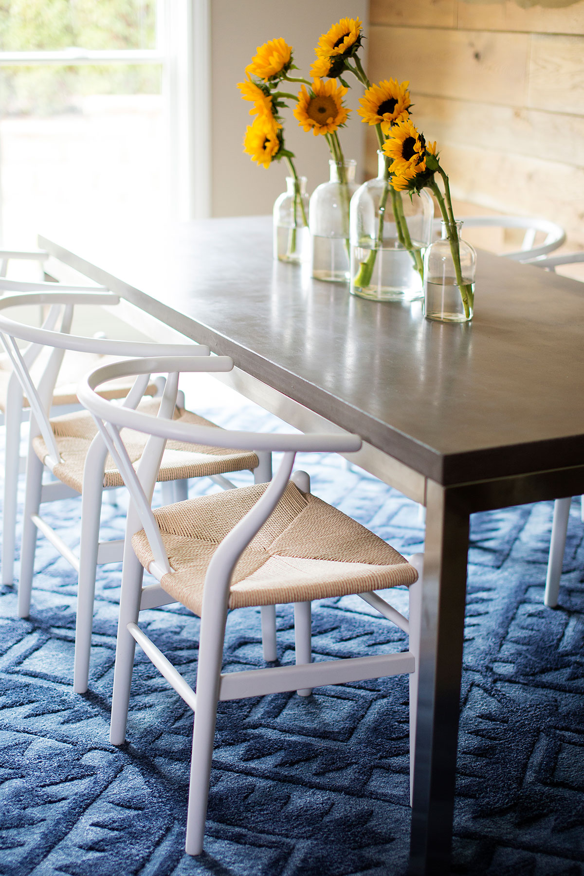 Metal dining table and Scandinavian dining chairs in basement