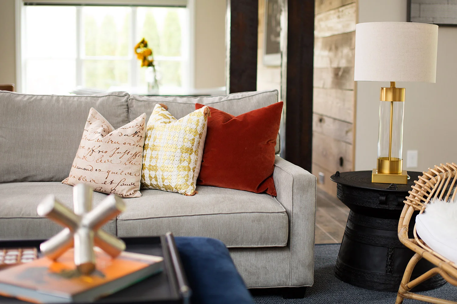 Casual basement with grey sofa and brass table lamp