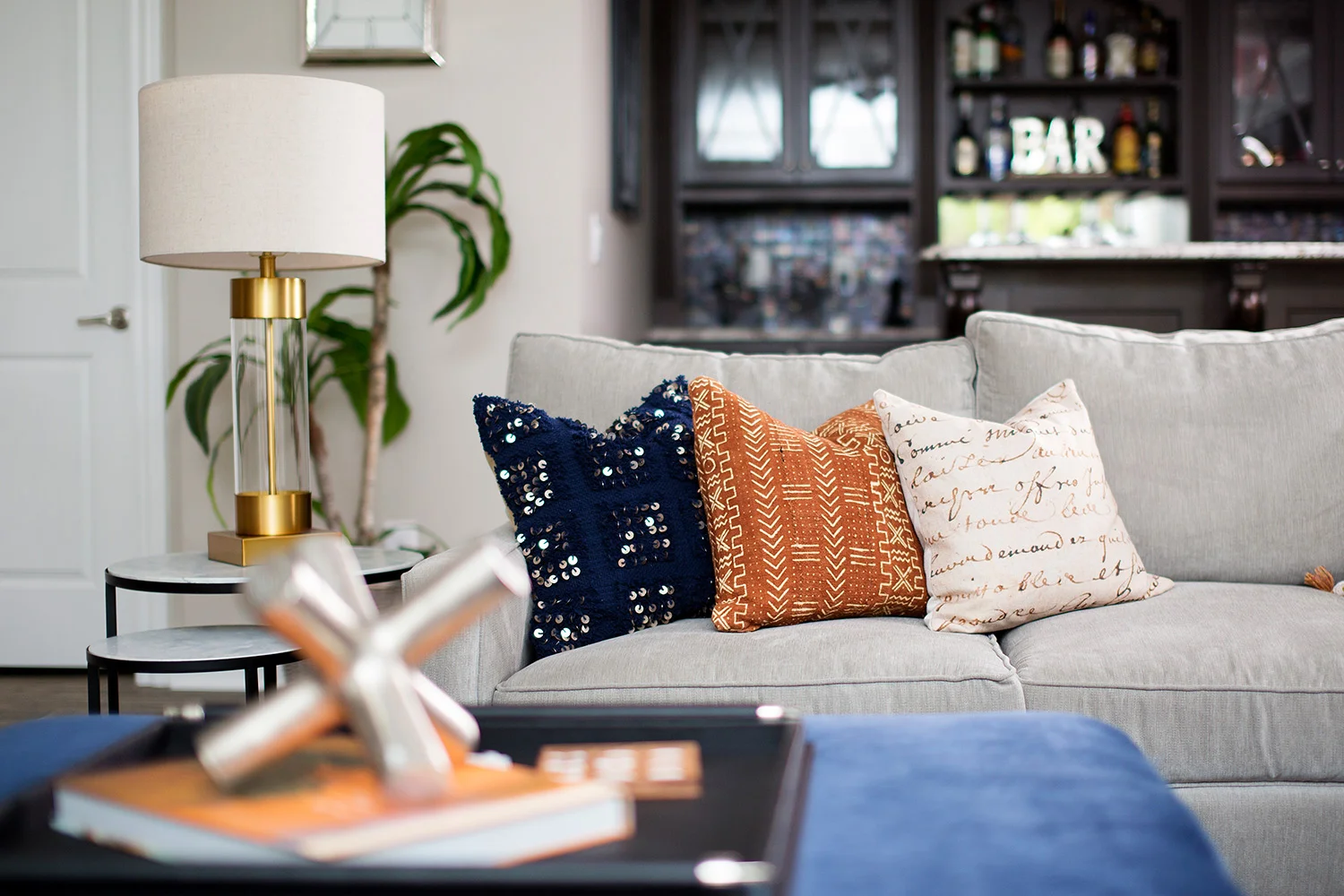 Casual basement with grey sofa and navy ottoman