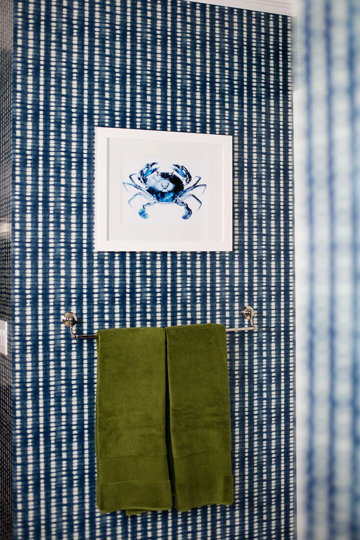 Blue and white wallpaper with crab artwork in transitional master bathroom