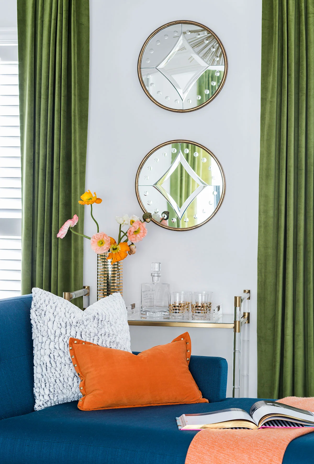 Round mirrors above bar cart in sitting room