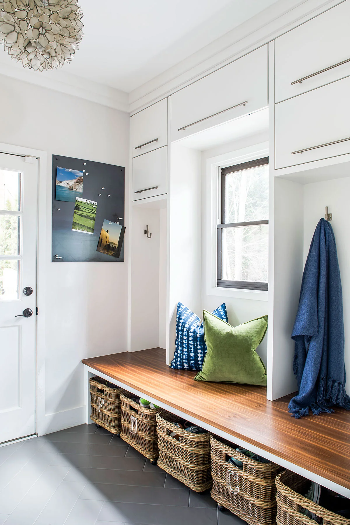 Contemporary mudroom with wood bench and under bench storage baskets