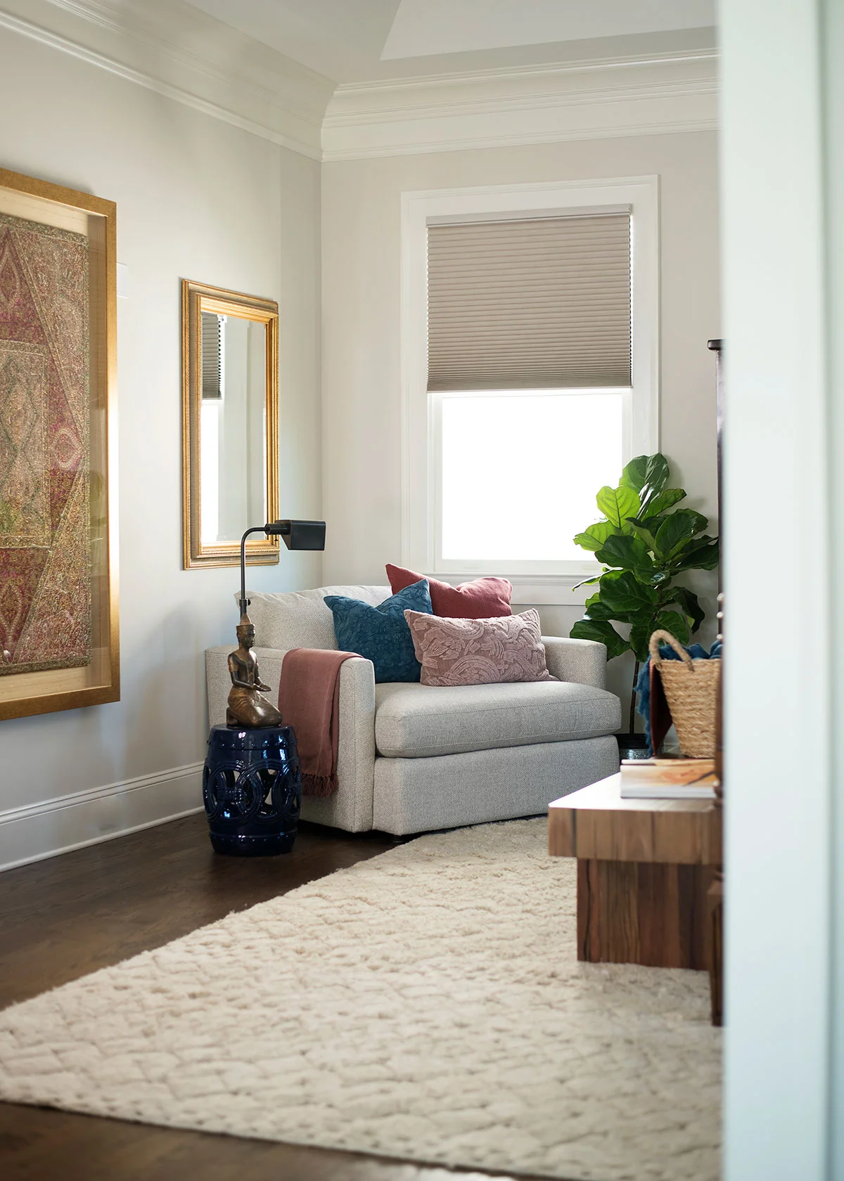 Sitting area in master bedroom with wood and brass accents