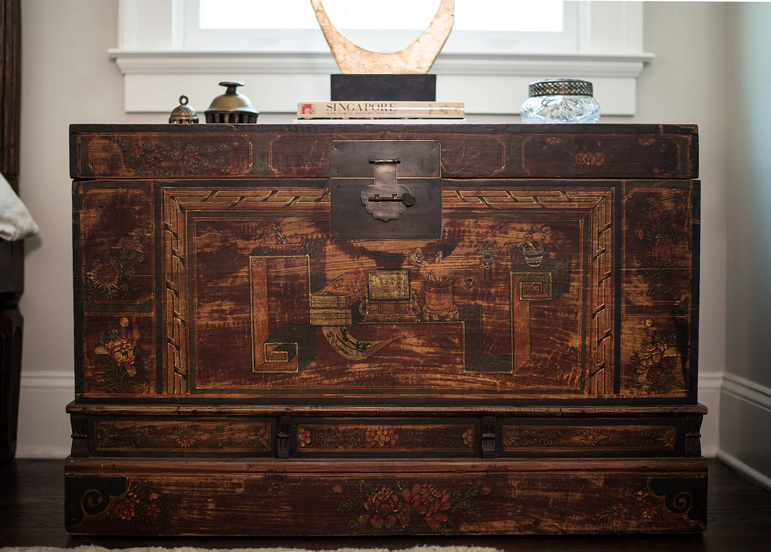 Antique Chinese trunk used as a night stand in master bedroom