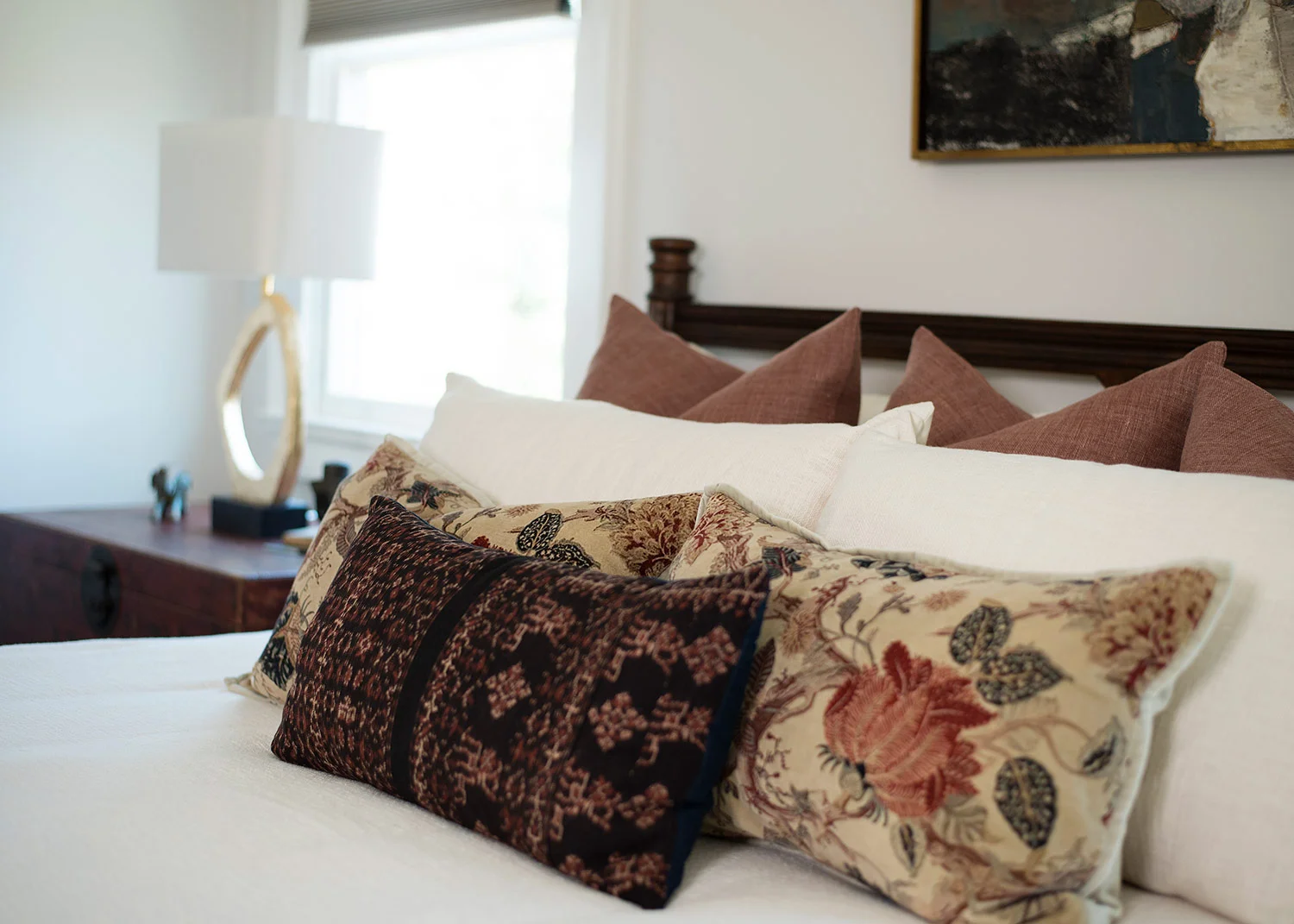Floral throw pillows on bed in master bedroom