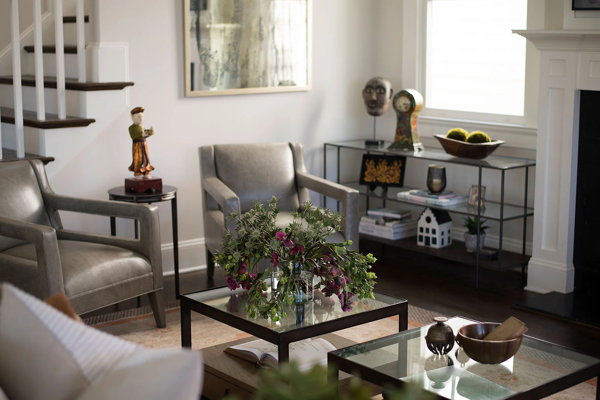 Leather chairs and glass shelving unit for displaying accessories