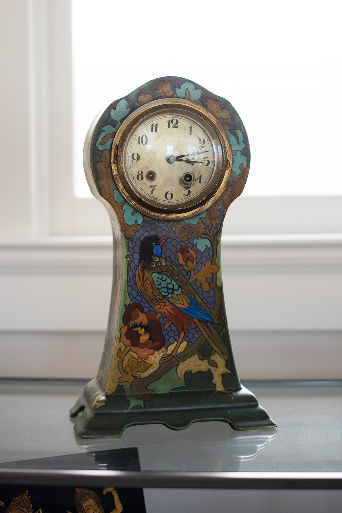 Antique painted clock with image of bird