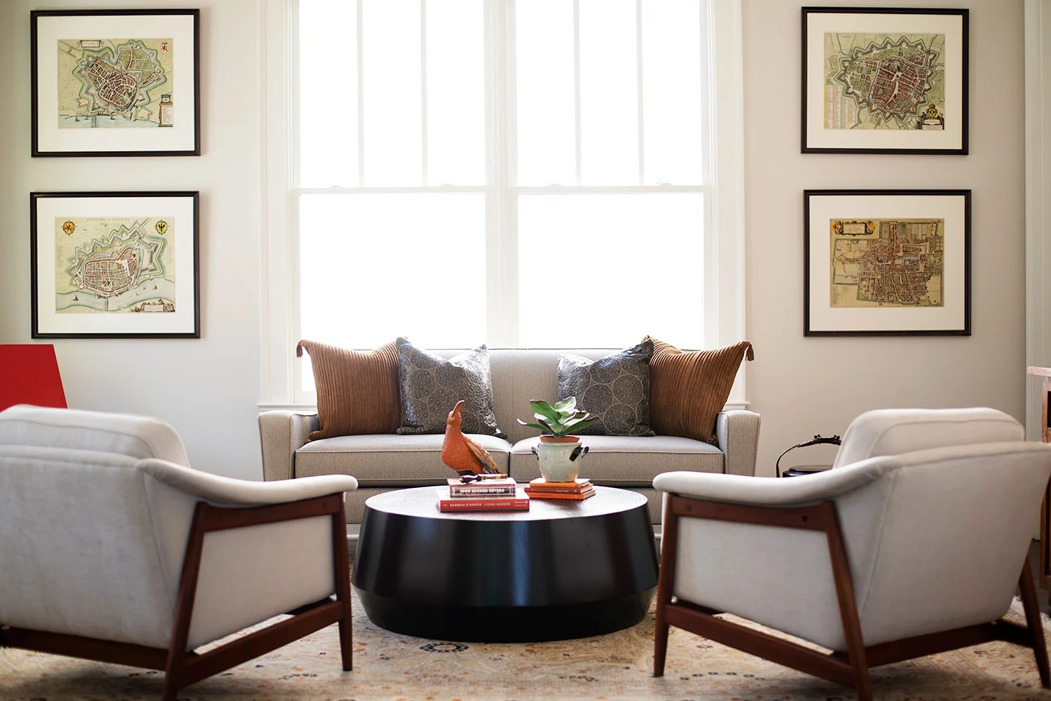 Transitional sitting room with beige furniture and round wood coffee table
