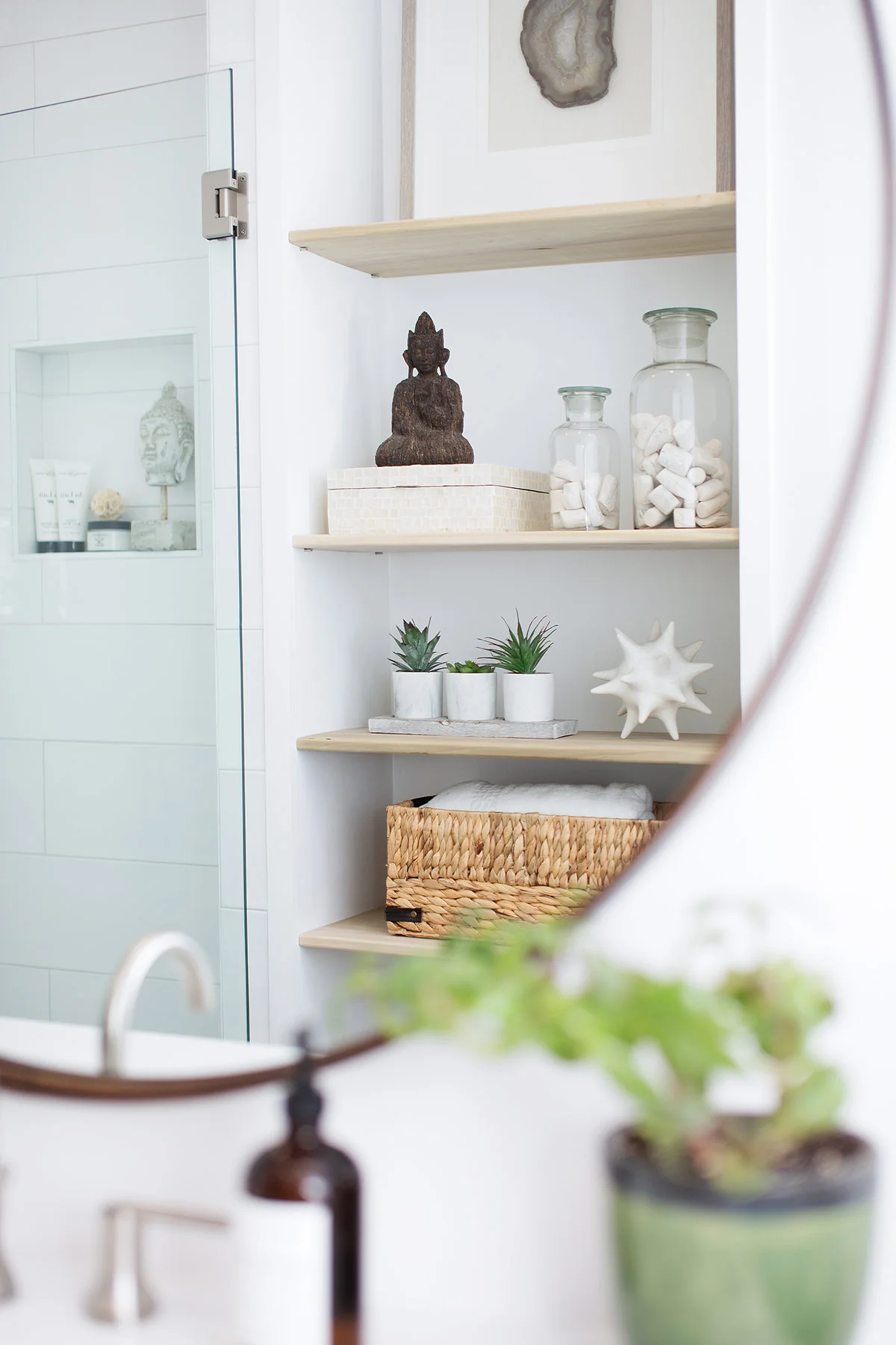 Built in floor to ceiling shelves in guest bathroom