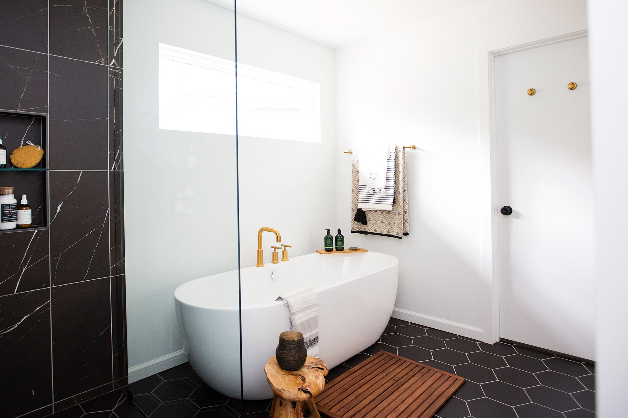 Midcentury modern master bathroom with freestanding tub and walk-in shower