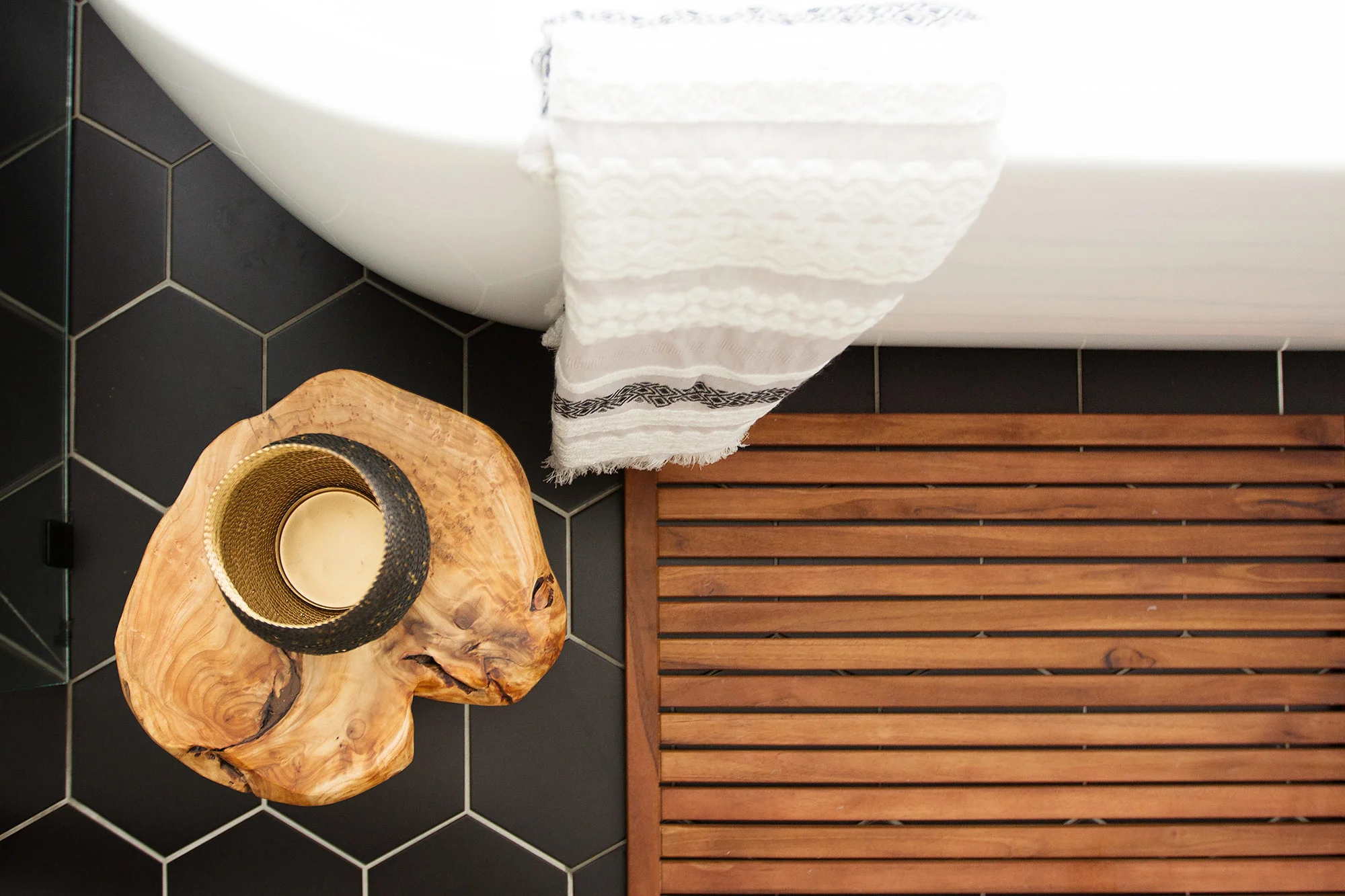 Black hex tiles and freestanding tub in midcentury modern master bathroom