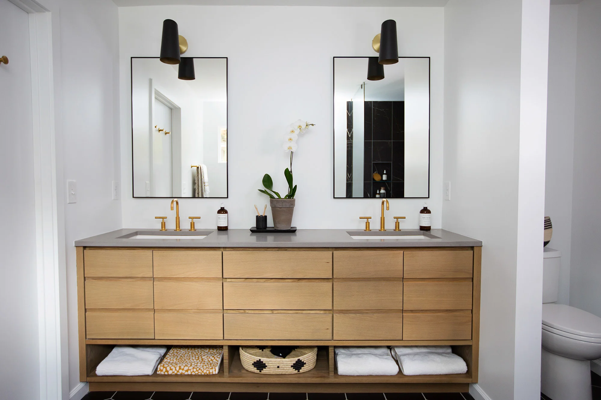 Built-in wood vanity in midcentury modern master bathroom