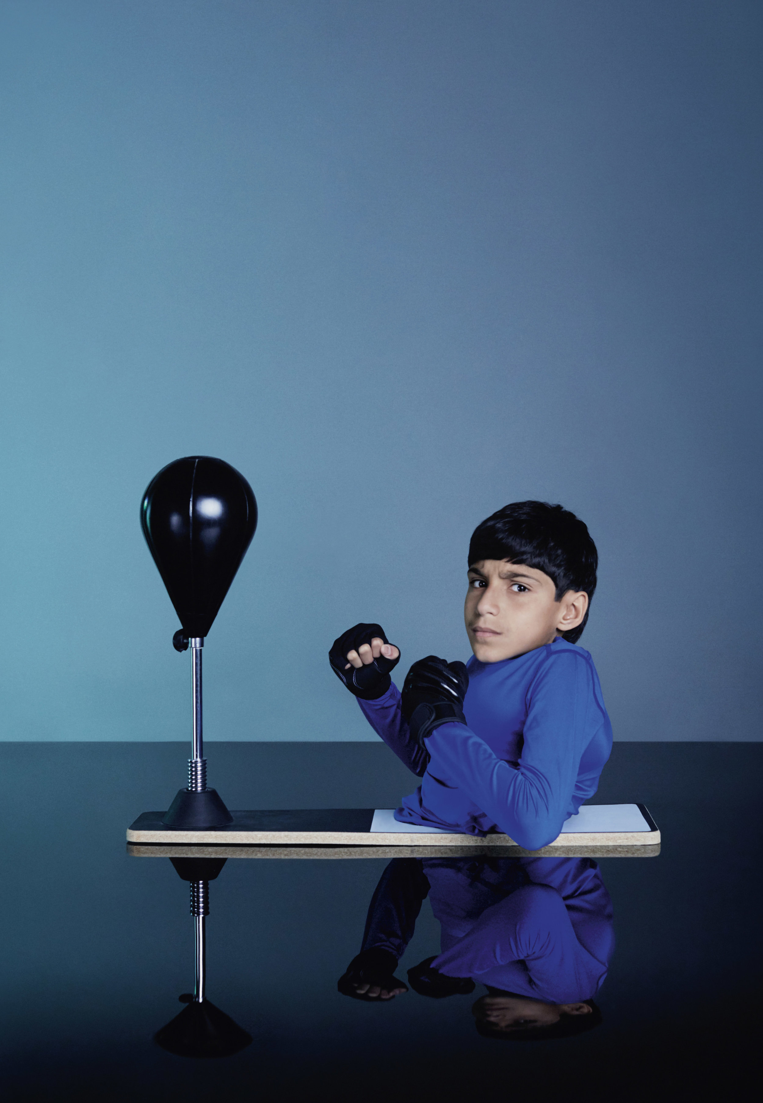 Ghanim the Boxer, 2016 Artist Statement Ghanim, who’s name means ‘winner’ in Arabic, is a 14-year-old, born with a rare disorder named Caudal Regression Syndrome (CDS), which impairs the development of the lower spine. ‘Ghanim The Winner’ is a self-initiated project, which documents this young athletes, passion for sport and his dreams of becoming a future Paralympian. Ghanim plays a huge part in changing perceptions on living with physical disabilities in the Middle East and especially in his home country of Qatar, where up until recently attitudes towards those with disability were that of exclusion and discrimination. A ROTA Goodwill Ambassador and an inspiration to thousands of people across the globe, raising awareness on persons living with physical disabilities, through his on-going charity work; as well as sharing his personal journey via social media with over 900,000 followers on Instagram (g_almuftah). The aim of my series was to capture him in his favourite sportswear and kit, as an example, his determination to succeed has resulted in him being one of the only divers in the world with his type of disability. Through this portrait series, I aim to showcasing his achievements whilst providing a message of hope and determination, echoing his belief that everyone has a right to dream and have ambitions which they can achieve.